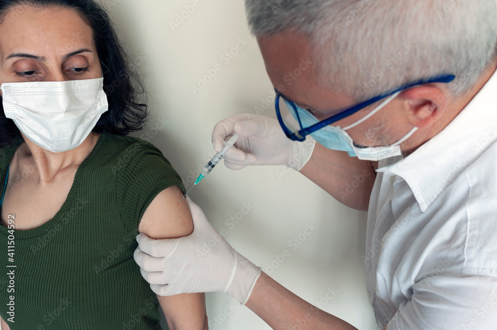 when the doctor vaccinated the woman, While the lady was getting vaccinated, vaccinating, vaccine when the doctor vaccinated the woman, While the lady was getting vaccinated, vaccinating, vaccine