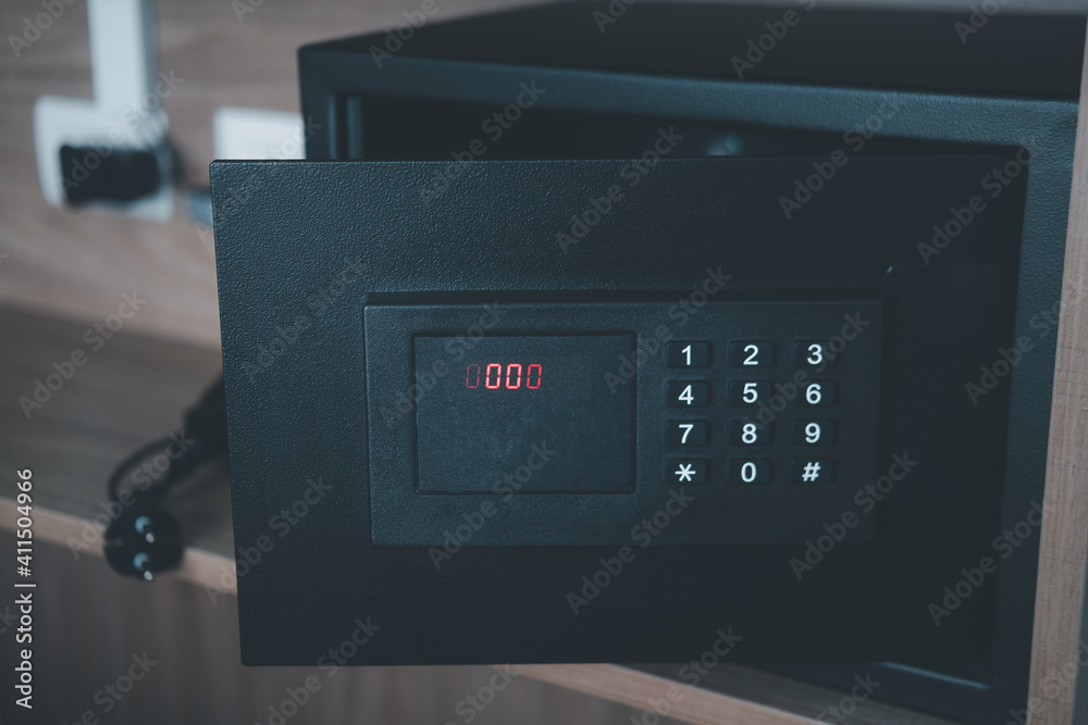 Opening black steel safe with electronic lock at hotel. Opening black steel safe with electronic lock at hotel.