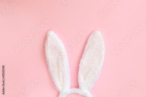 Foto Funny Easter bunny ears isolated on pastel pink background