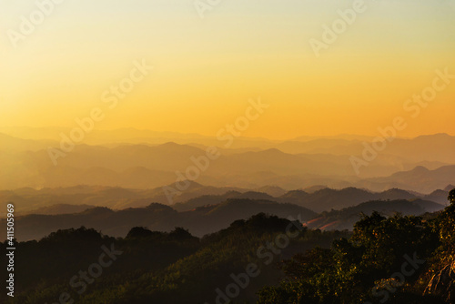 landscape in thailand sunrise on mountains peaceful with mist and sunlight at morning picturesque scenery outdoors travel.