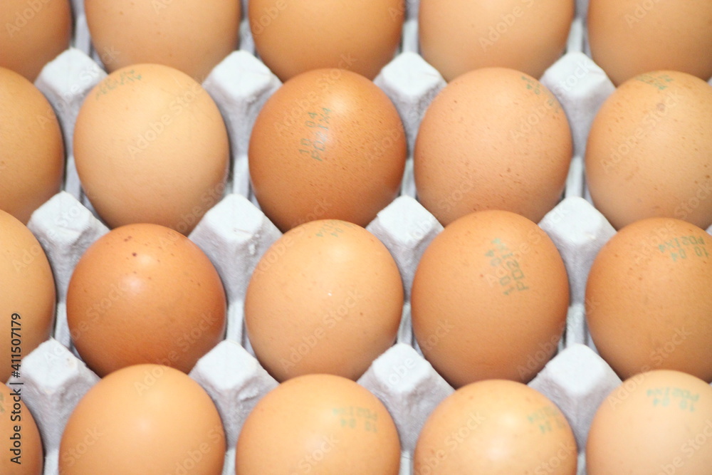 Closeup view with selective focus on fresh farm chicken eggs in an egg-carton Closeup view with selective focus on fresh farm chicken eggs in an egg-carton