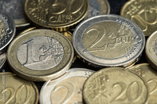 Euro coins of different denominations close-up lie sloppy on the plane