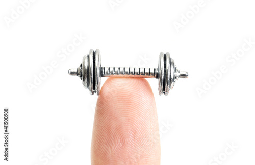 Cropped view of a tiny dumbbell on a fingertip isolated on white photo