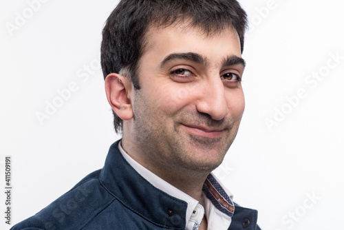 Portrait of caucasian man with brown eyes expressing positive emotions in studio, with white background