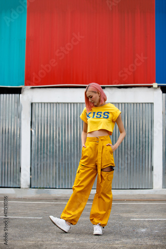 Street Fashion Woman with dying Pink Hair color wear yellow chic dress