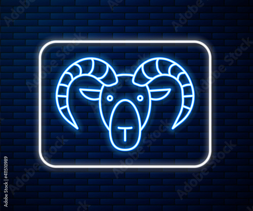 Glowing neon line Head of goat or ram icon isolated on brick wall background. Mountain sheep. Animal symbol. Vector.