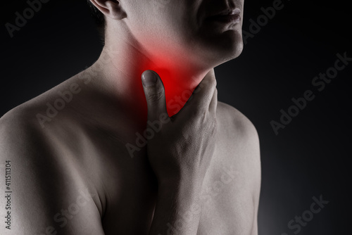 Sore throat, men with pain in neck on black background