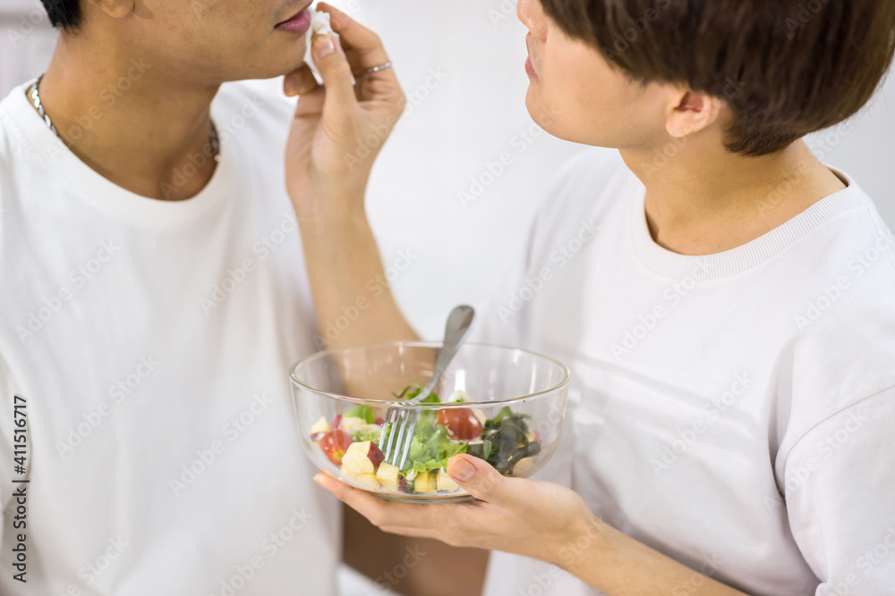 Gay man wipe boyfriend mouth after feeding salad Gay man wipe boyfriend mouth after feeding salad
