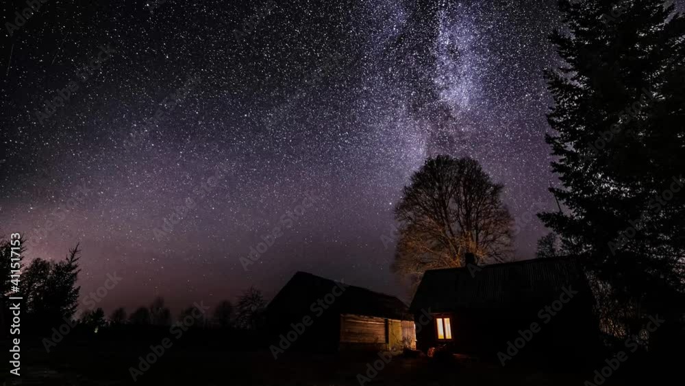 Milky way timelapse with stars in clear summer night. Old barn house. Country side. Timelapse footage.