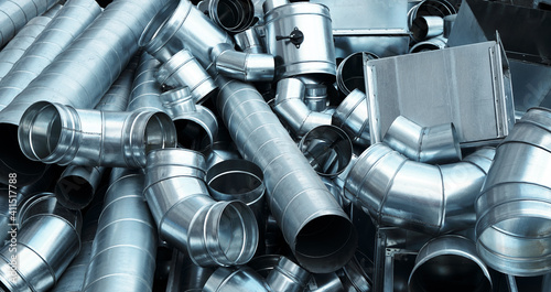 Pile of pipes and parts for duct systems. Industrial ventilation photo