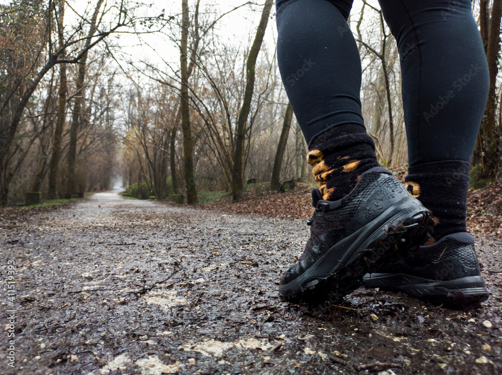 Trekking boots on a muddy pathway Trekking boots on a muddy pathway