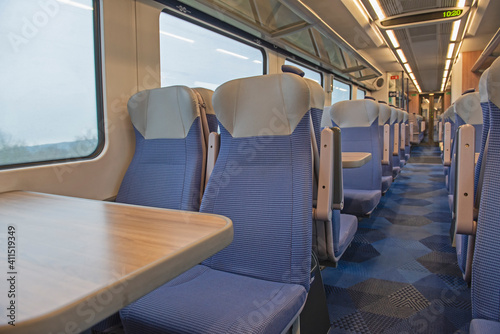Interior of an empty commuter train carriage with seats © Paul Vinten