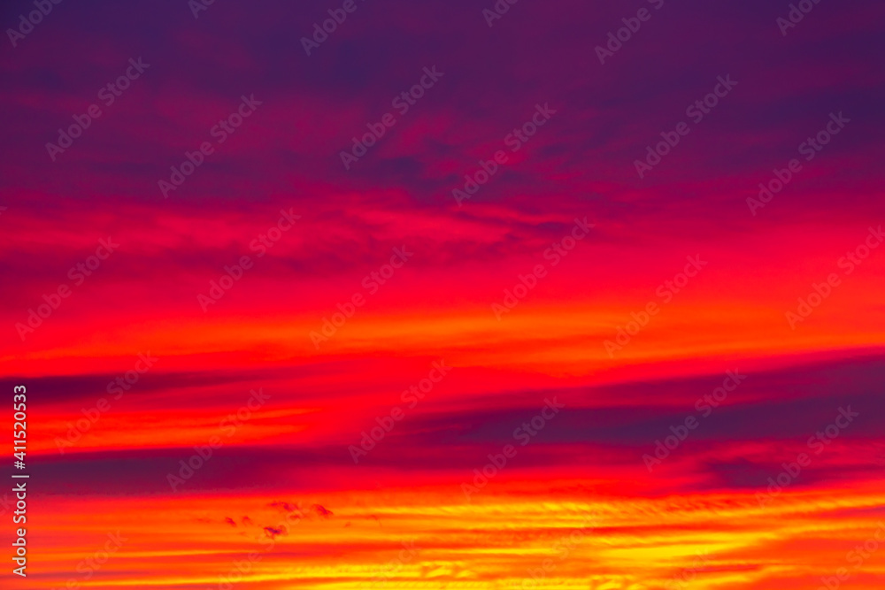 Vivid saturated beautiful sunset sky in red, purple and blue colors. Sunset background