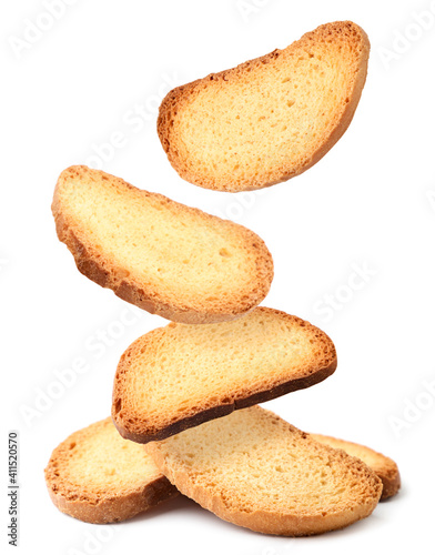 Tableau sur toile Bread rusks falling on a heap on a white background, levitating crackers
