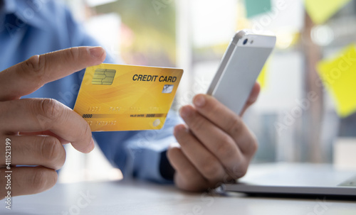 Businessman use mobile phones to register for security Online with a credit card to buy products online through application, Online shopping or Internet technology concept.
