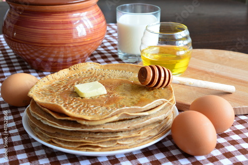 pancakes with honey butter eggs and glass of milk