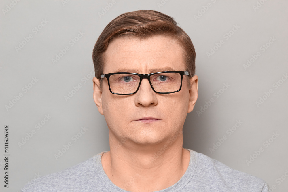 Portrait of mature man with glasses with serious expression on face