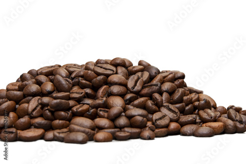 A pile of roasted coffee beans on a white background  close-up  selective focus  isolate.