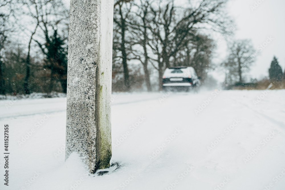 back side of blurry car on snowy road back side of blurry car on snowy road