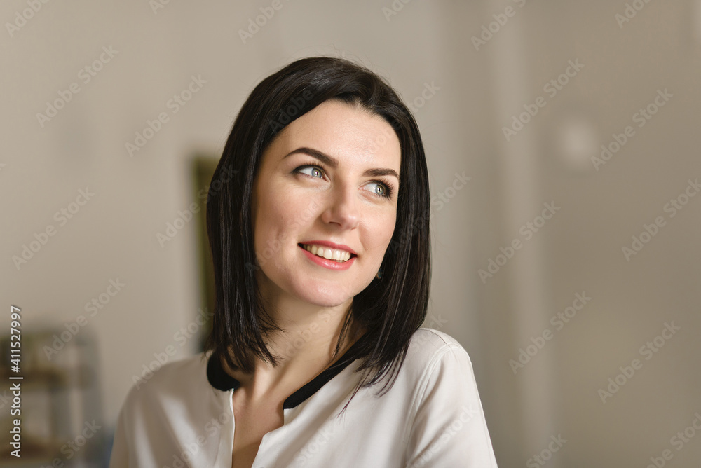 a brunette woman portrait in the office sits at the table a brunette woman portrait in the office sits at the table