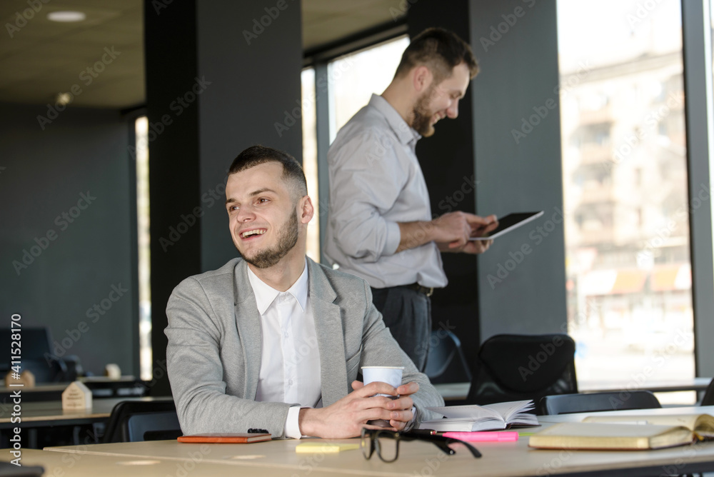Two men talking about business in the office Two men talking about business in the office