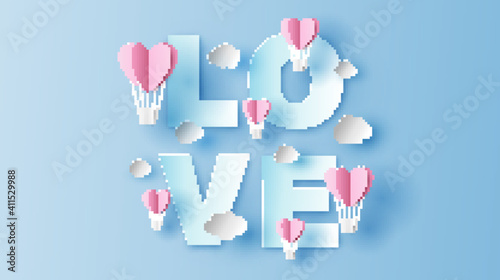 Calligraphy of Love with heart shape hot air balloon floating on sky background. Love Invitation card for Valentine's day. paper cut and craft style. vector, illustration.