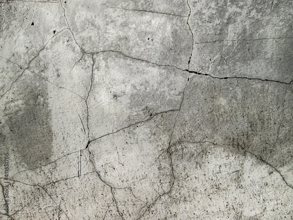 Cracked concrete surface. Broken cement. The texture is damaged and cracked.