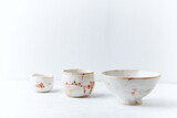 Traditional, handcrafted ceramic on bright wooden background. Soft focus. Copy space.
