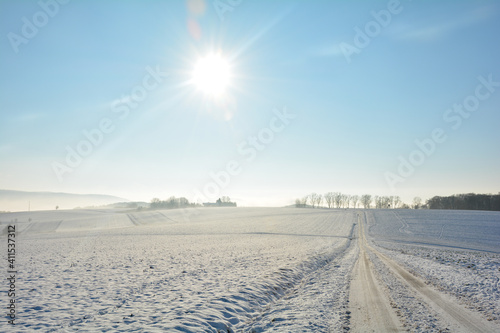 Snow-covered road in winter in the countryside