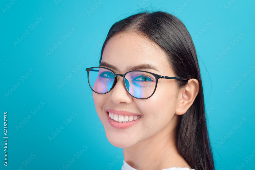 Portrait of young female wearing glasses over blue background studio, healthcare concept Portrait of young female wearing glasses over blue background studio, healthcare concept