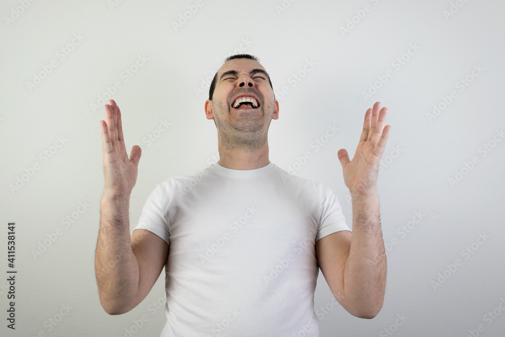 happy excited young man stand white background laugh hands up crazy look angry happy excited young man stand white background laugh hands up crazy look angry