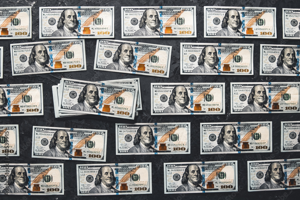 One hundred dollar bills are creatively laid out. Business concept, development perspective. One hundred dollar bills are creatively laid out. Business concept, development perspective.