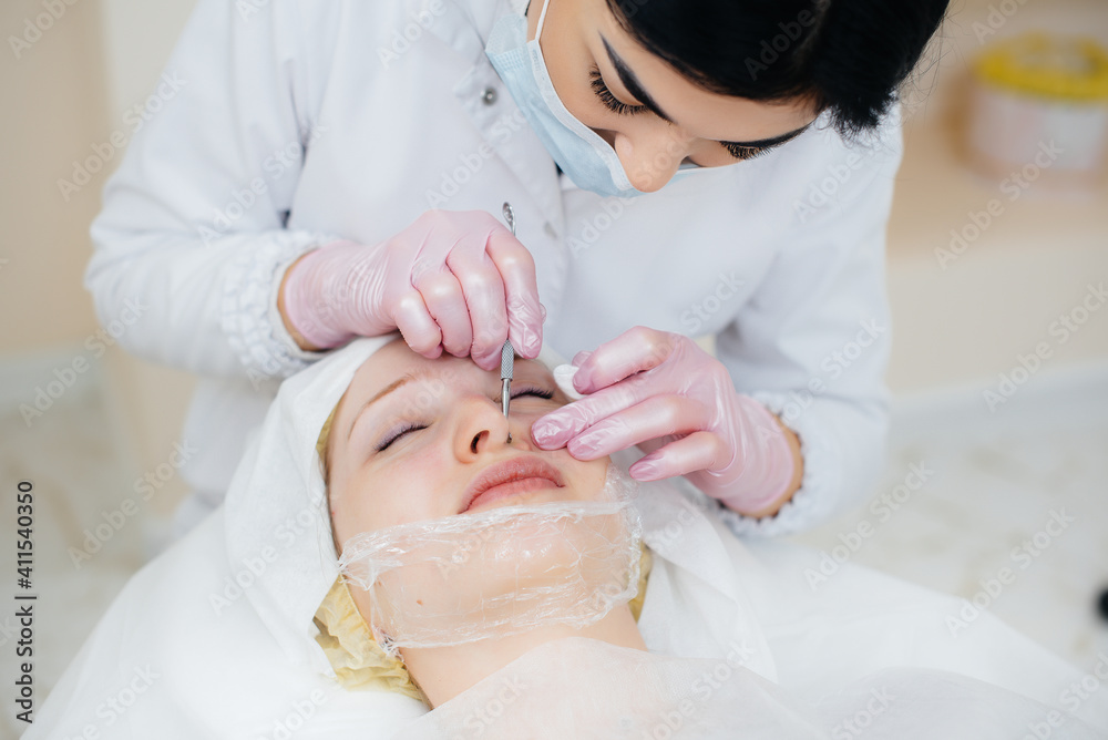 Young girls do mechanical face cleaning in a modern cosmetology clinic. Cosmetology. Young girls do mechanical face cleaning in a modern cosmetology clinic. Cosmetology.