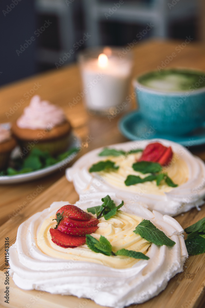 Meringue and whipped cream dessert layered with seasonal strawberry.