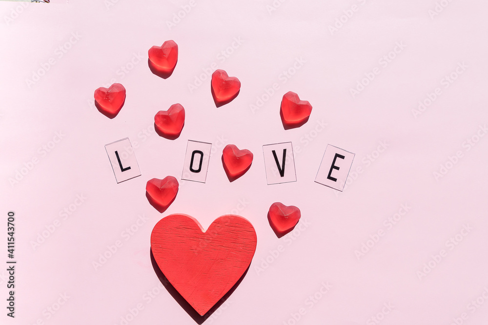 Banner.The word Love.Black letters Love with Red hearts.on pink background.Valentine's day. Loving, positive emotions. Feelings backdrop. Exclusive relationships.