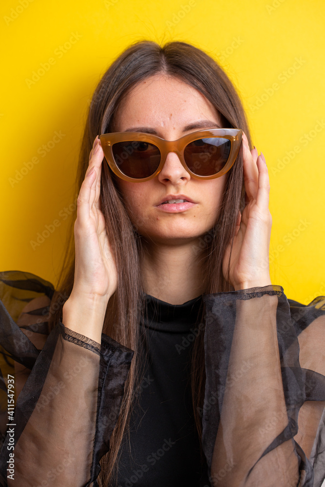 young woman with make-up in sunglasses and on yellow background young woman with make-up in sunglasses and on yellow background