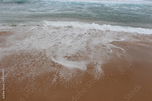 Sandy beach with beautiful water waves