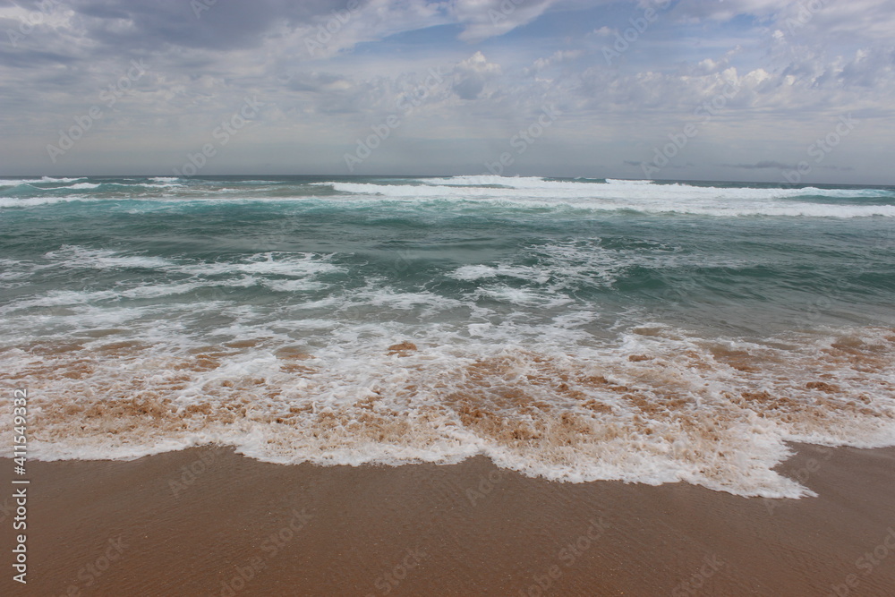 Sandy beach with beautiful water waves