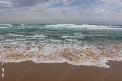 Sandy beach with beautiful water waves