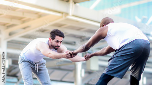 African american man and caucasian man is outdoor exercising, stretching workout, warm up, Portraits of different nationalities and skin tones between blacks and Caucasian people