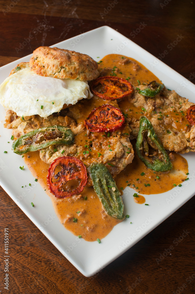 Chicken fried steak. Flank steak battered & deep fried in cast iron skillet. Classic American southern, low country cuisine. Made from scratch chicken fried steak served with gravy and side dishes.
