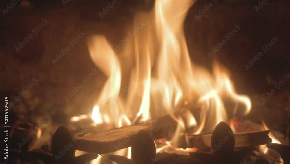 Logs burning in a romantic fire in a dark room