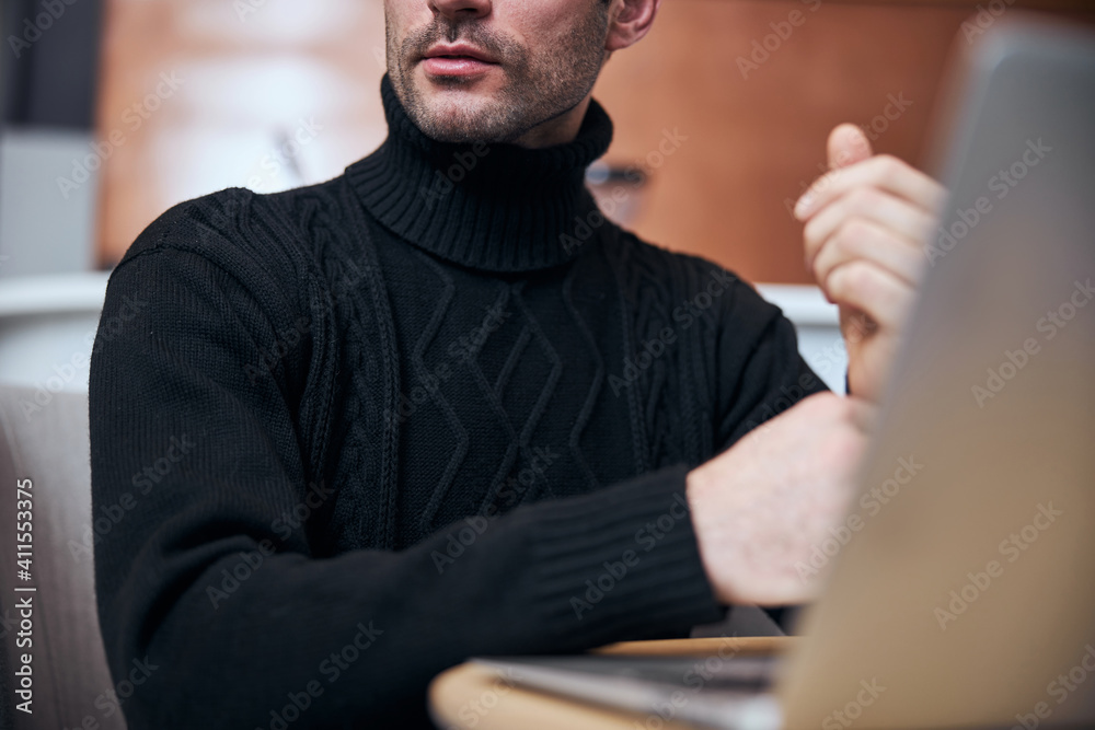 Young businessman working on notebook in lobby Young businessman working on notebook in lobby