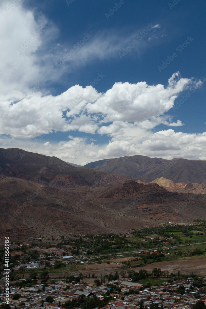 View of Humahuaca ravine, the rocky Andes mountains and Tilcara village under a cloudy sky in Jujuy, Argentina.