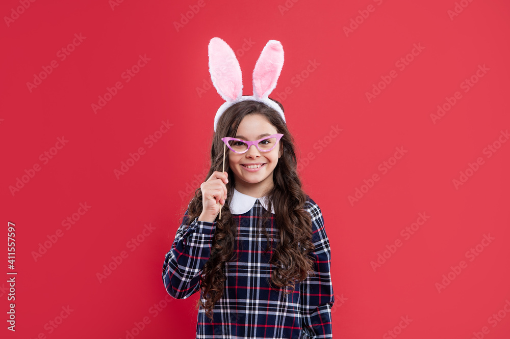 happy child girl in easter bunny ears and party glasses having fun, easter holiday