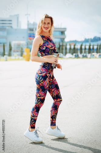 Beautiful blonde girl posing in trendy sportswear