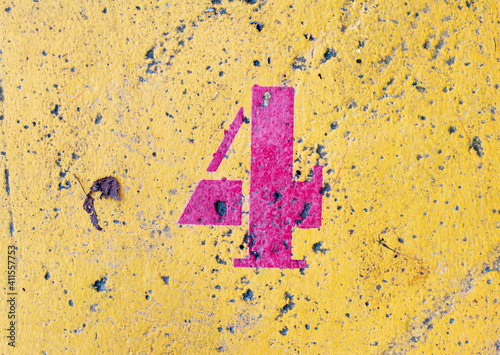 number 4 on a colored concrete floor