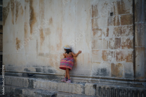 Girl balancing on an edge in the old town of Trogir