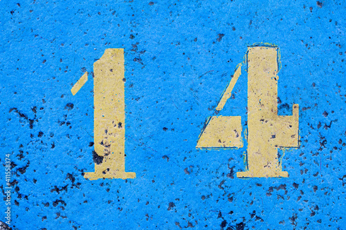 number 14 on a colored concrete floor