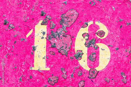 number 16 on a colored concrete floor